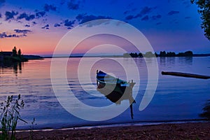 Sunset reflection on Lake Seliger with a boat